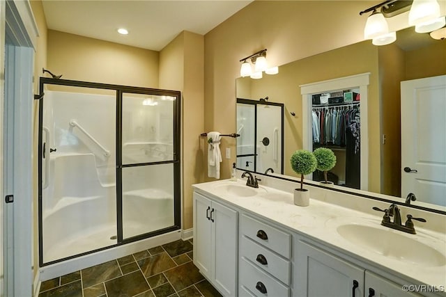 7413 Settlers Ridge Ct, Henrico, VA 23231 - bathroom featuring a shower stall, double vanity, and a walk in closet