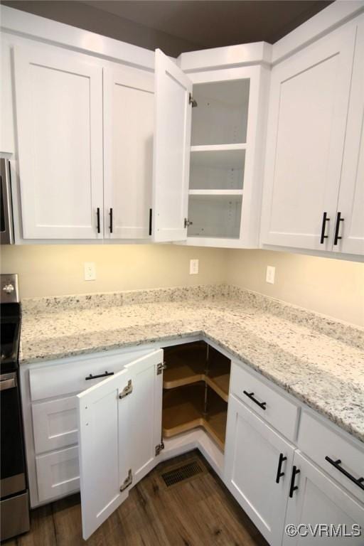 5104 Front Dr, North Dinwiddie, VA 23803 - kitchen featuring electric range, white cabinets, dark wood finished floors, and light stone counters