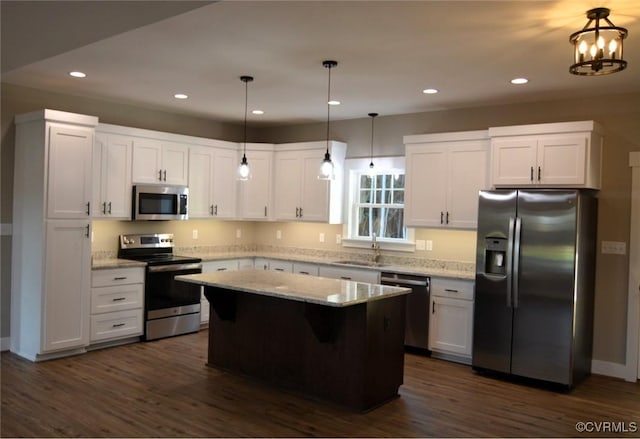 5104 Front Dr, North Dinwiddie, VA 23803 - kitchen with appliances with stainless steel finishes, white cabinets, a kitchen island, dark wood-style flooring, and recessed lighting