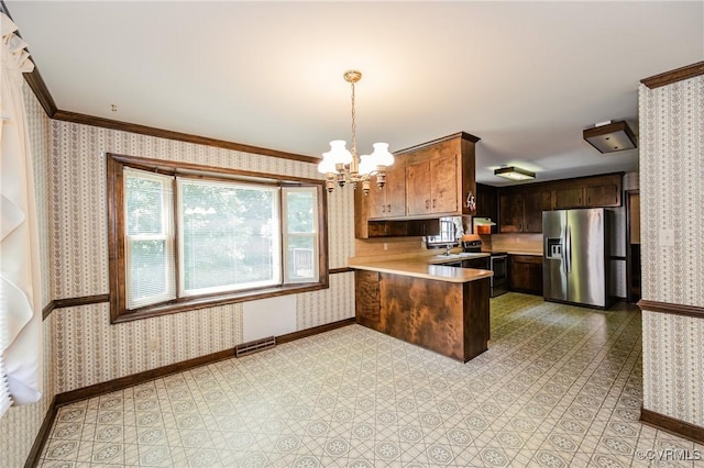 4320 Dunraven Rd, Chesterfield, VA 23236 - kitchen with stainless steel fridge, black range with electric stovetop, wallpapered walls, light countertops, and a peninsula