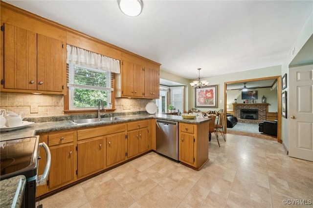 3000 Cove Ridge Rd, Midlothian, VA 23112 - kitchen featuring stainless steel appliances, a peninsula, brown cabinets, and a fireplace