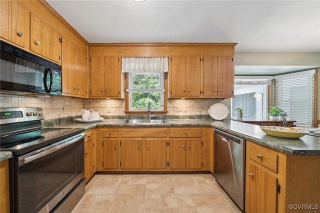 3000 Cove Ridge Rd, Midlothian, VA 23112 - kitchen with appliances with stainless steel finishes, tasteful backsplash, a peninsula, and brown cabinetry