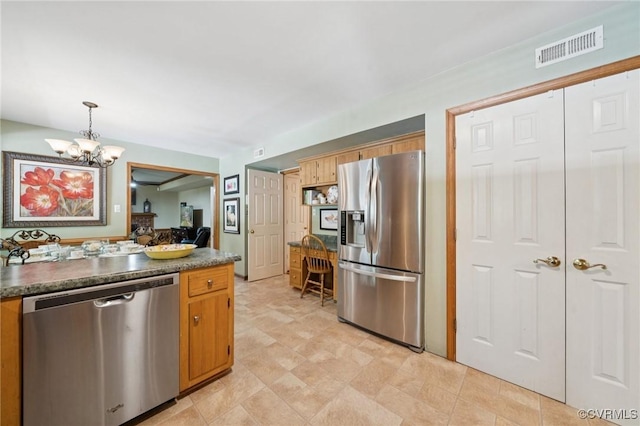3000 Cove Ridge Rd, Midlothian, VA 23112 - kitchen featuring appliances with stainless steel finishes, a chandelier, dark countertops, and pendant lighting