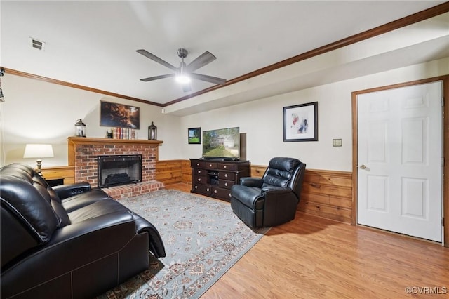 3000 Cove Ridge Rd, Midlothian, VA 23112 - living room with light wood finished floors, a ceiling fan, wainscoting, crown molding, and a brick fireplace