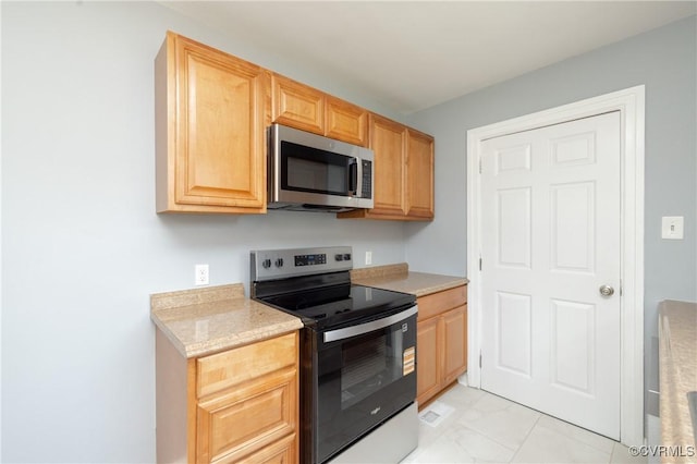 6500 W Grace St, Henrico, VA 23226 - kitchen with stainless steel appliances, light marble finish flooring, light countertops, and light brown cabinetry