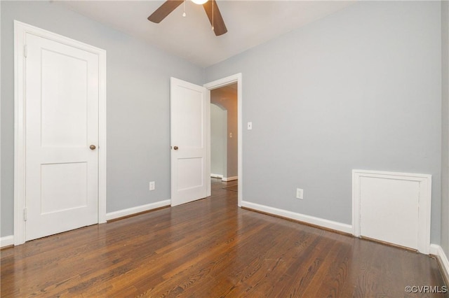 6500 W Grace St, Henrico, VA 23226 - unfurnished bedroom featuring wood finished floors, ceiling fan, and arched walkways
