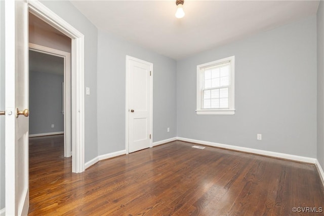 6500 W Grace St, Henrico, VA 23226 - unfurnished bedroom featuring wood finished floors and baseboards