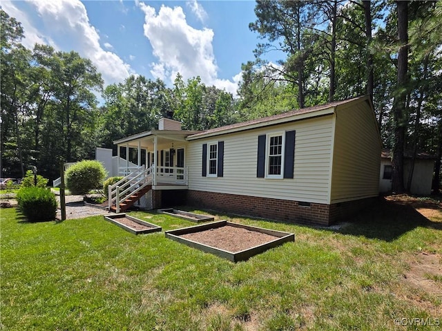 11220 Sunfield Dr, Midlothian, VA 23112 - back of property featuring crawl space, a vegetable garden, a lawn, and a chimney
