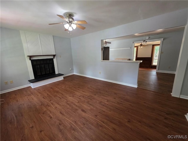 11220 Sunfield Dr, Midlothian, VA 23112 - unfurnished living room featuring ceiling fan, a large fireplace, and dark wood finished floors