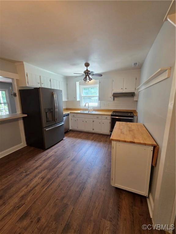 11220 Sunfield Dr, Midlothian, VA 23112 - kitchen with stainless steel appliances, wooden counters, under cabinet range hood, white cabinets, and dark wood-type flooring