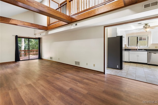 1453 Lockett Ridge Rd, Midlothian, VA 23114 - unfurnished living room with a towering ceiling, ceiling fan, and light wood-style floors