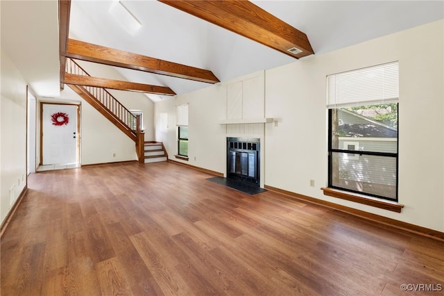 1453 Lockett Ridge Rd, Midlothian, VA 23114 - unfurnished living room featuring beamed ceiling, wood finished floors, stairs, a fireplace with flush hearth, and high vaulted ceiling