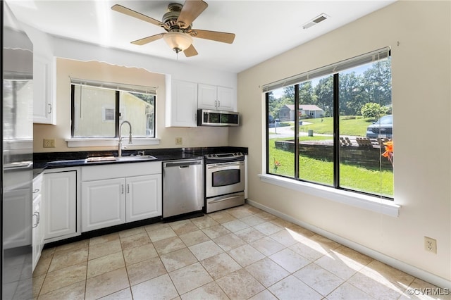 1453 Lockett Ridge Rd, Midlothian, VA 23114 - kitchen featuring appliances with stainless steel finishes, dark countertops, white cabinetry, and a ceiling fan
