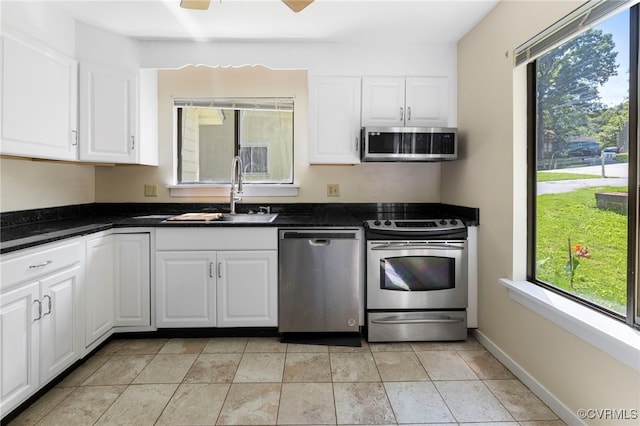 1453 Lockett Ridge Rd, Midlothian, VA 23114 - kitchen with stainless steel appliances, plenty of natural light, white cabinetry, and dark countertops