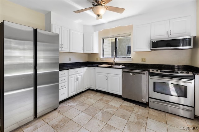 1453 Lockett Ridge Rd, Midlothian, VA 23114 - kitchen featuring appliances with stainless steel finishes, dark countertops, and white cabinets