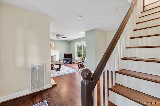 3167 Trenholm Rd, Powhatan, VA 23139 - staircase featuring ceiling fan, wood finished floors, a fireplace, and recessed lighting