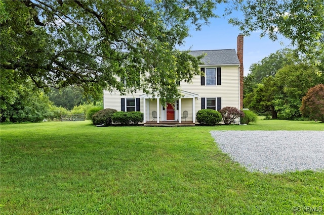 3167 Trenholm Rd, Powhatan, VA 23139 - view of front of house featuring a chimney, a front lawn, and covered porch