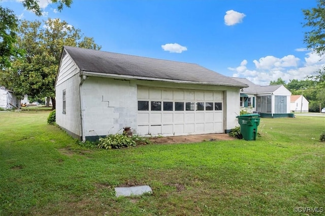 1415 New Market Rd 1411, Henrico, VA 23231 - view of side of home featuring a lawn, a detached garage, and roof with shingles