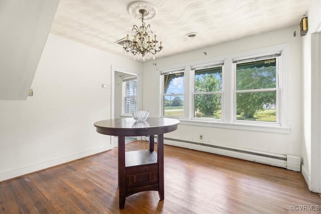 1415 New Market Rd 1411, Henrico, VA 23231 - dining room featuring a baseboard heating unit, wood finished floors, and a chandelier
