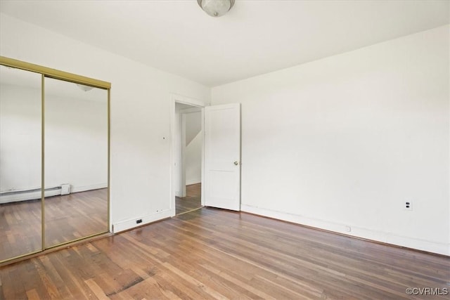 1415 New Market Rd 1411, Henrico, VA 23231 - unfurnished bedroom with baseboard heating, wood finished floors, and a closet