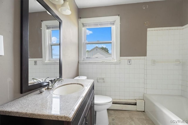 1415 New Market Rd 1411, Henrico, VA 23231 - bathroom with vanity, tile walls, a tub to relax in, a baseboard heating unit, and wainscoting