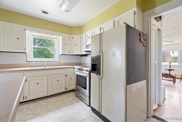 1415 New Market Rd 1411, Henrico, VA 23231 - kitchen featuring white fridge with ice dispenser, stainless steel range with electric stovetop, healthy amount of natural light, and white cabinets