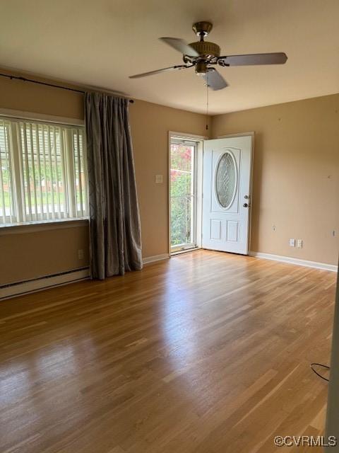 4002 Crystalwood Ln, Henrico, VA 23294 - foyer entrance featuring wood finished floors, a ceiling fan, and a baseboard radiator