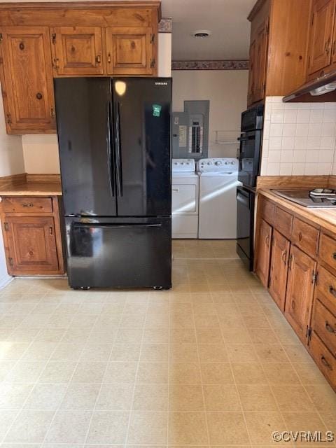4002 Crystalwood Ln, Henrico, VA 23294 - kitchen featuring black appliances, independent washer and dryer, brown cabinetry, under cabinet range hood, and tasteful backsplash