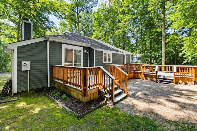 14408 Woods Walk Ct, Midlothian, VA 23112 - back of house with a chimney, a deck, and view of wooded area