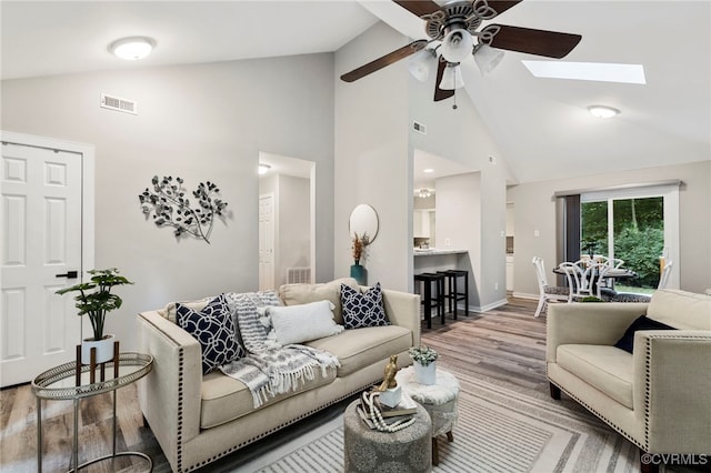 14408 Woods Walk Ct, Midlothian, VA 23112 - living area featuring wood finished floors, a ceiling fan, high vaulted ceiling, and a skylight