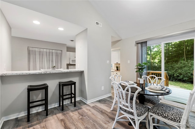 14408 Woods Walk Ct, Midlothian, VA 23112 - dining area featuring wood finished floors, recessed lighting, and high vaulted ceiling