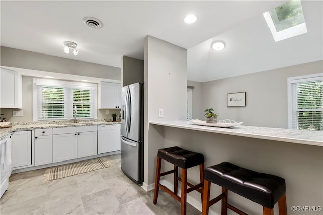 14408 Woods Walk Ct, Midlothian, VA 23112 - kitchen featuring dishwasher, stainless steel refrigerator with ice dispenser, a skylight, and plenty of natural light