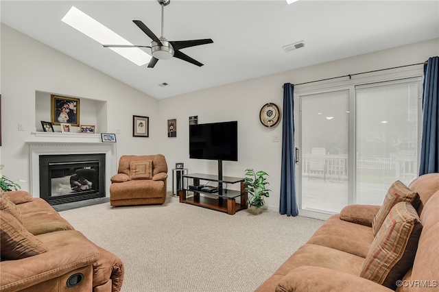 4055 Tanner Slip Cir, Chester, VA 23831 - carpeted living area with vaulted ceiling, ceiling fan, a glass covered fireplace, and a skylight