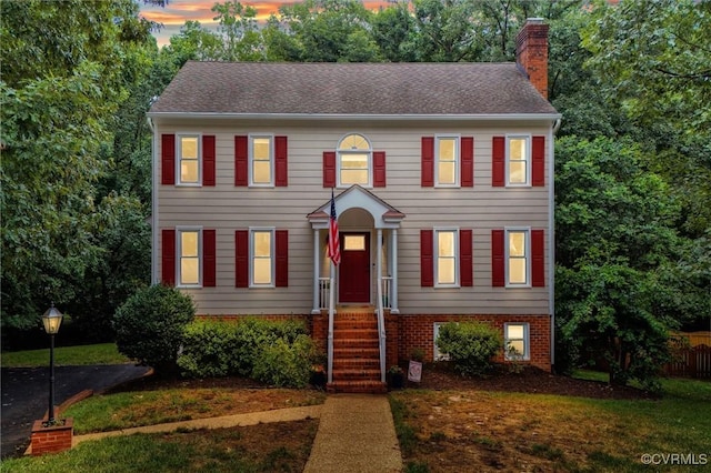 6003 Lansgate Rd, Midlothian, VA 23112 - colonial home with a chimney, brick siding, and roof with shingles