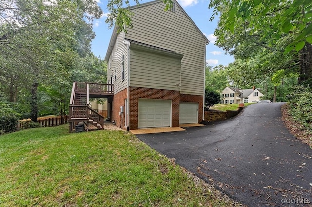 6003 Lansgate Rd, Midlothian, VA 23112 - view of side of home with a garage, stairs, a yard, asphalt driveway, and brick siding