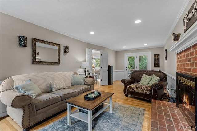 6003 Lansgate Rd, Midlothian, VA 23112 - living area with crown molding, a wainscoted wall, a brick fireplace, light wood-style flooring, and recessed lighting