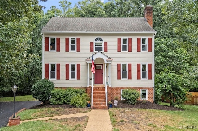 6003 Lansgate Rd, Midlothian, VA 23112 - colonial house featuring a chimney, brick siding, and a shingled roof