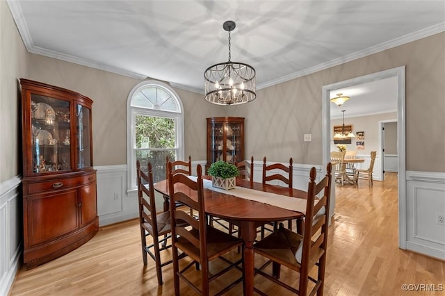 6003 Lansgate Rd, Midlothian, VA 23112 - dining area with a chandelier, light wood-type flooring, ornamental molding, wainscoting, and a decorative wall