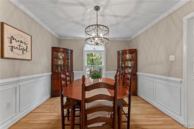 6003 Lansgate Rd, Midlothian, VA 23112 - dining area featuring a chandelier, light wood-type flooring, crown molding, a wainscoted wall, and a decorative wall