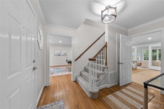 13219 Lauren Ln, Midlothian, VA 23114 - foyer entrance featuring wood finished floors, stairs, and ornamental molding