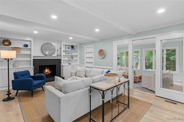 13219 Lauren Ln, Midlothian, VA 23114 - living room with beamed ceiling, light wood-style floors, a brick fireplace, recessed lighting, and built in features