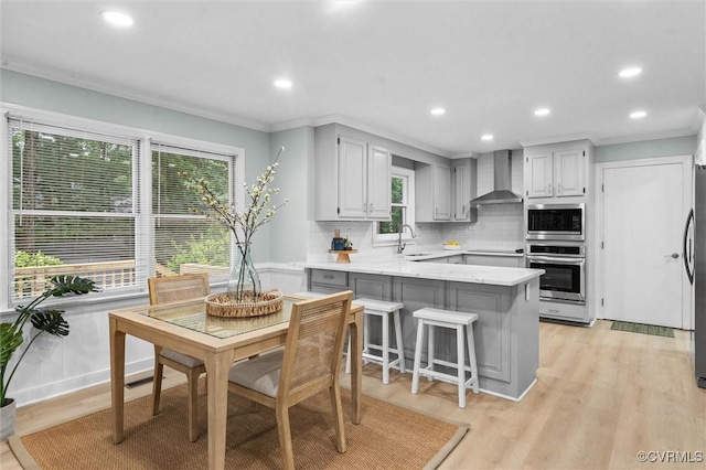 13219 Lauren Ln, Midlothian, VA 23114 - kitchen featuring a peninsula, ornamental molding, tasteful backsplash, stainless steel appliances, and wall chimney exhaust hood