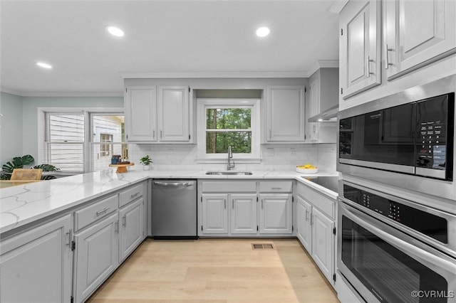 13219 Lauren Ln, Midlothian, VA 23114 - kitchen with stainless steel appliances, crown molding, tasteful backsplash, recessed lighting, and light wood-style floors