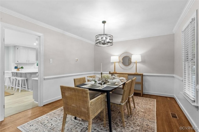 13219 Lauren Ln, Midlothian, VA 23114 - dining area with light wood-type flooring, ornamental molding, and a chandelier