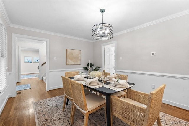 13219 Lauren Ln, Midlothian, VA 23114 - dining space with a chandelier, wood finished floors, crown molding, and stairs