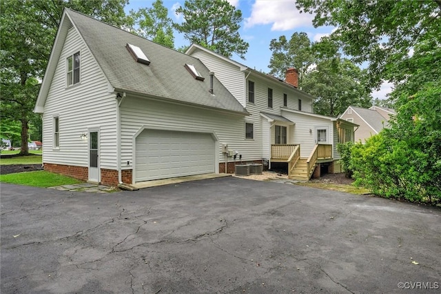13219 Lauren Ln, Midlothian, VA 23114 - view of side of property with driveway, a garage, roof with shingles, and a chimney