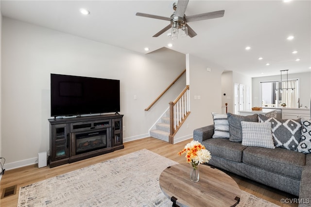 1665 Ewing Park Loop, Midlothian, VA 23113 - living room with light wood-type flooring, stairs, recessed lighting, a ceiling fan, and arched walkways