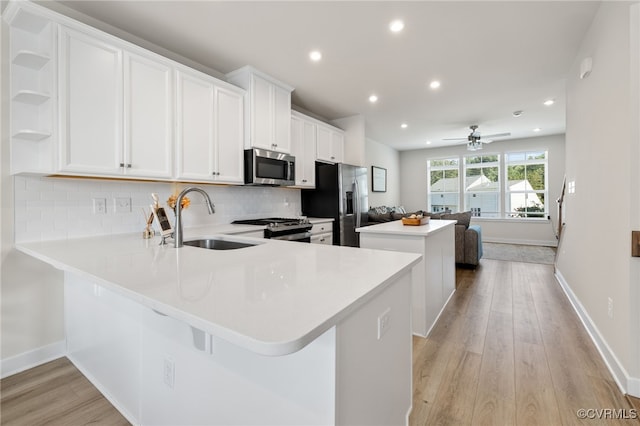 1665 Ewing Park Loop, Midlothian, VA 23113 - kitchen with a center island, light wood-type flooring, decorative backsplash, recessed lighting, and white cabinetry