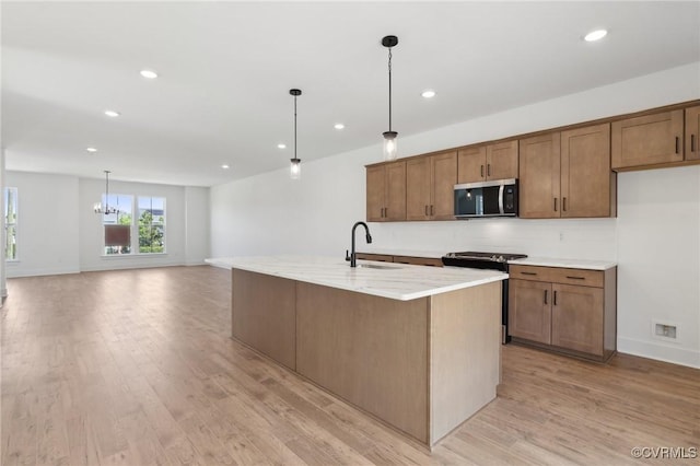 12149 Morning Walk, Henrico, VA 23233 - kitchen with stainless steel microwave, range with gas stovetop, recessed lighting, light wood-style flooring, and pendant lighting