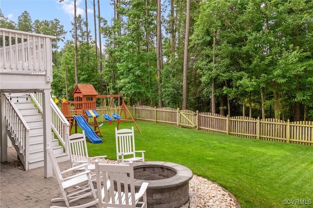 18007 Twin Falls Ln, Moseley, VA 23120 - fenced backyard featuring a fire pit, stairs, a playground, a patio area, and view of wooded area